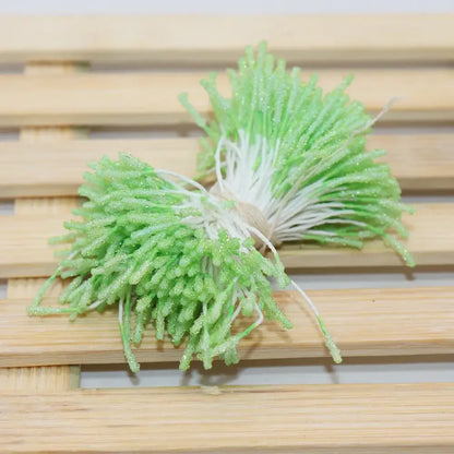 A bundle of artificial green glittery mini flower stamen sprouts with white stems tied together for kids bedroom hair ties