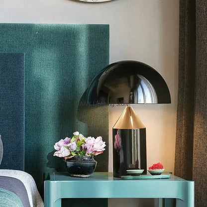 Glossy black and gold metal table lamp with sleek dome-shaped shade ideal for decorbites atollo bedroom light
