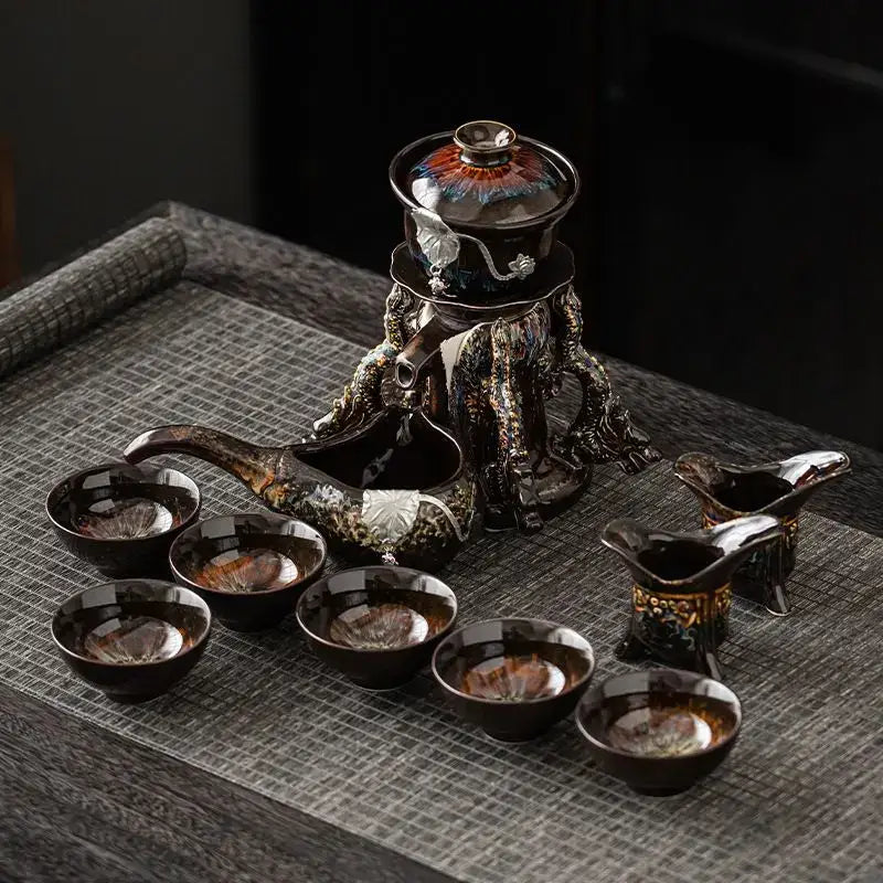 Elegant ceramic magnetic rotating tea set with dark glossy glaze and intricate dragon base decorbites dragon teapot