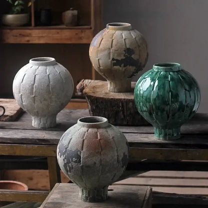 Handcrafted green ceramic spherical vase with ribbed texture and earthy glazes for living room decor