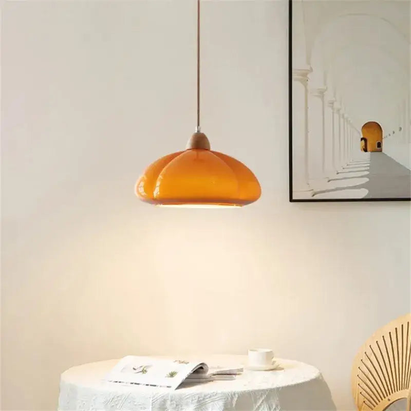 Glossy orange glass pumpkin chandelier with warm amber glass pendant light and wooden top for bedroom lighting