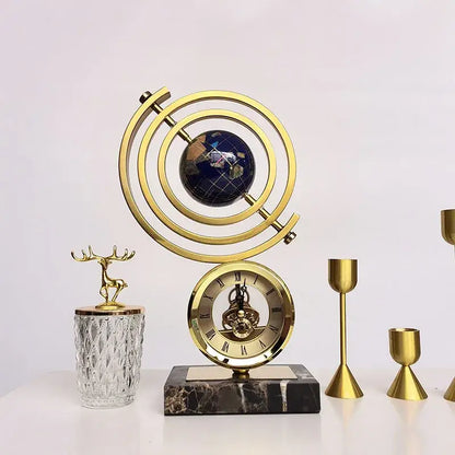Gold and blue clock globe decoration with dark blue world map sphere encased in brass rings on black marble base