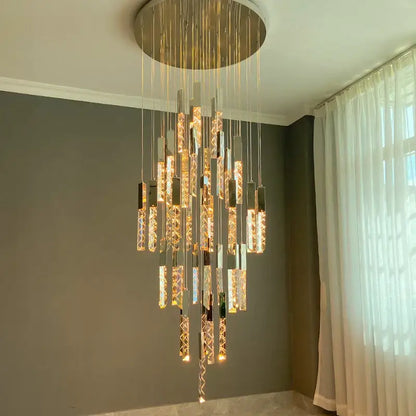 A gold and crystal led chandelier with circular gold mount and hanging rods emitting warm light for staircase decorbites crystal led