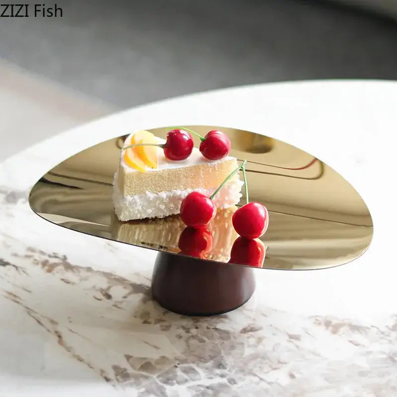 Shiny gold metallic cake stand with dark wood base in a fruit bowl tray set for kitchen use and serving