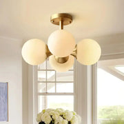 Gold-toned semi-flush mount ceiling fixture with four opaline glass globe shades compatible with 220v-240v 110v-120v