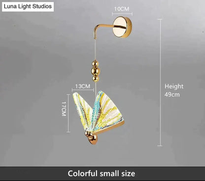 Gold and patterned butterfly led wall light with gold finish and colorful yellow teal wings for bedroom decor