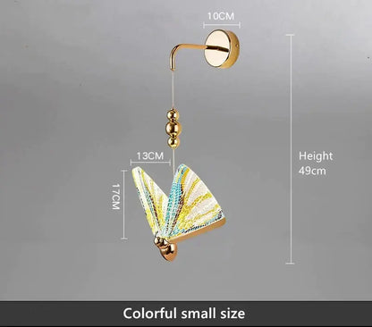Gold and patterned butterfly led wall light with decorative gold-toned frame and iridescent yellow blue wings for bedroom