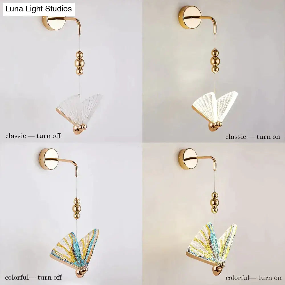 Gold and patterned butterfly led wall light with gold finish and delicate fan-shaped glass shade glows warmly in bedroom