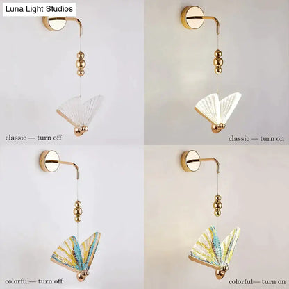 Gold and patterned butterfly led wall light with gold finish and delicate fan-shaped glass shade glows warmly in bedroom
