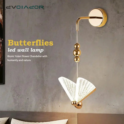 Gold and patterned butterfly led wall light with gold finish and translucent fan-like wings for bedroom use