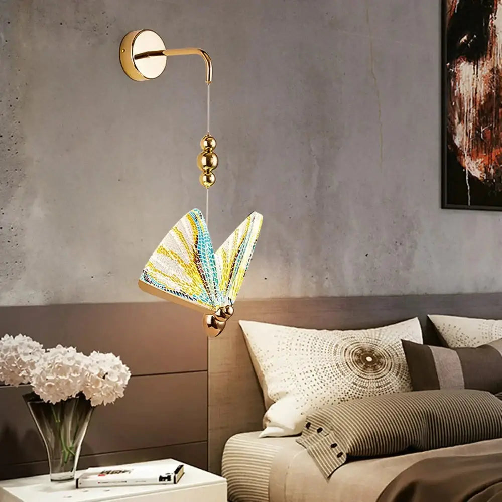 Gold and patterned butterfly led wall light featuring a gold-toned sconce with intricate yellow blue white lampshade