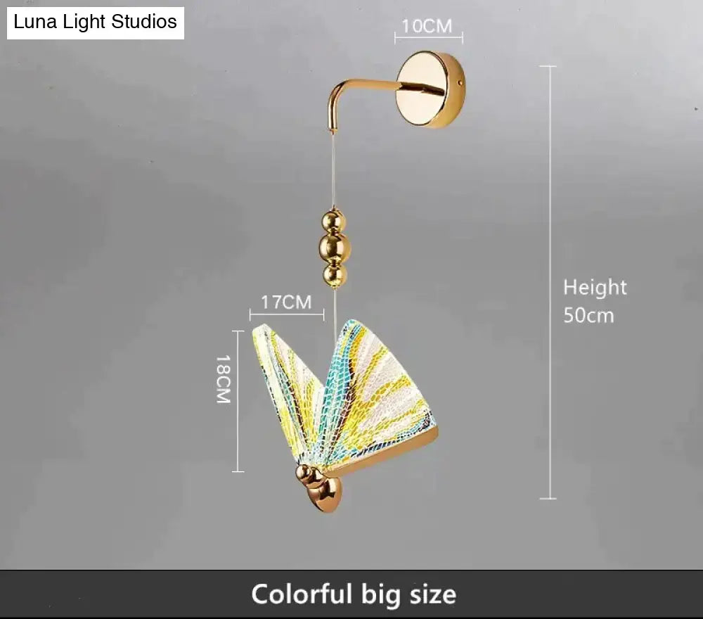 A vibrant gold and patterned butterfly led wall light with yellow and teal wings for bedroom decor