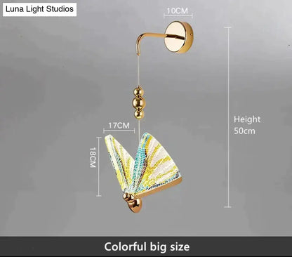A vibrant gold and patterned butterfly led wall light with yellow and teal wings for bedroom decor