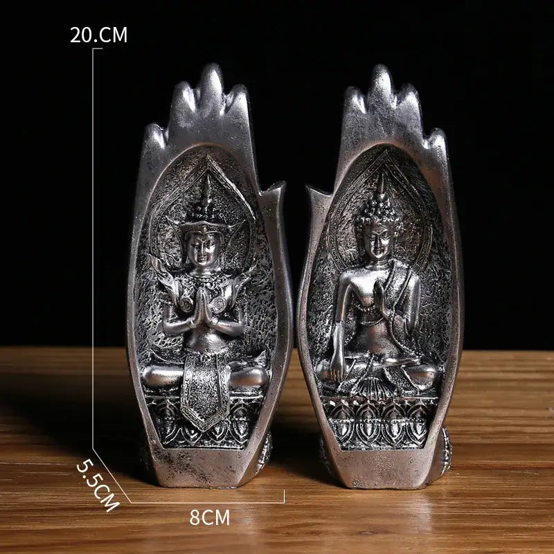 Silver-colored intricately detailed buddha hands monk figurine seated in open hand-shaped base for living room decor