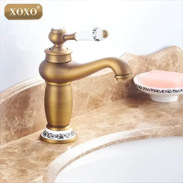 Antique brass finished single handle deck mounted basin faucet with white ceramic handle and mosaic tile base decorbites bathroom basin