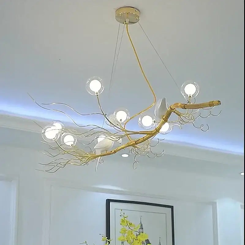 Gold and white iron branch led pendant chandelier with clear glass globe lights and ceramic birds for dining room use