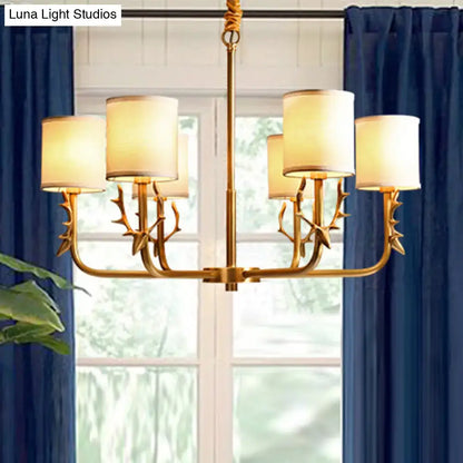 Gold antler fabric shade cylindrical chandelier with gold-toned antler deco arms and cream fabric shades for living room light