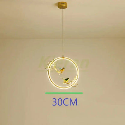 Gold bird led chandelier with a gold-toned metal frame and two glowing birds on branches for dining room decorbites bird led