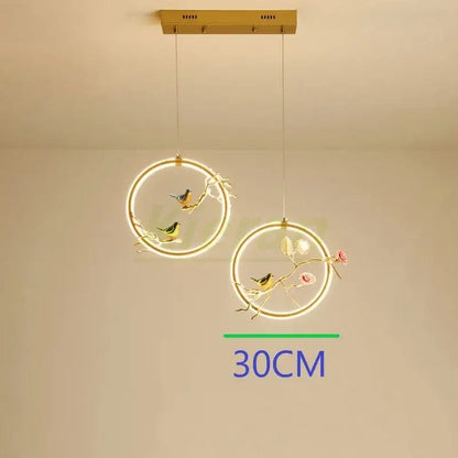 Gold bird led chandelier floral pendant light with gold-toned birds and blossoms illuminated by soft led rings by decorbites bird led