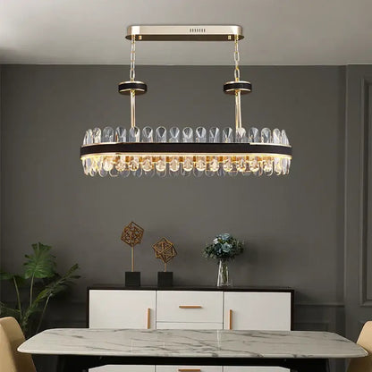 Gold and black decorbites crystal oval chandelier with gold tone and dangling crystal droplets for dining room light