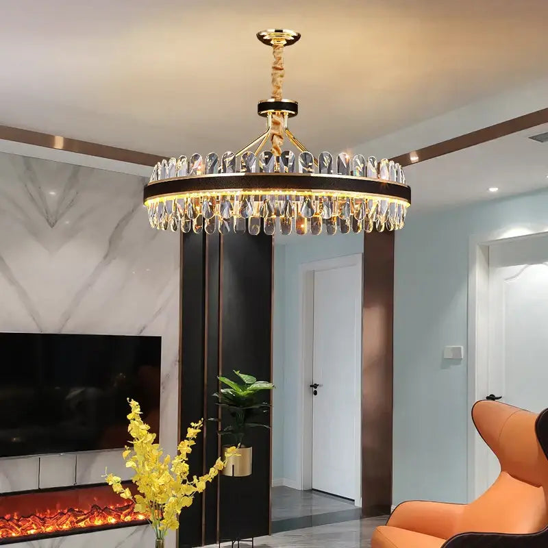 Gold and black decorbites crystal oval chandelier with gold-toned circular frame and dangling crystal droplets for dining room decor