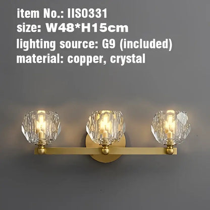 Gold-toned copper wall sconce with three faceted crystal shades for bathroom vanity light fixtures