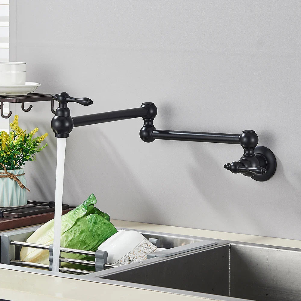 Black matte-finish extendable kitchen faucet with ornate spherical accents and dual handles in gold brass pot filler design