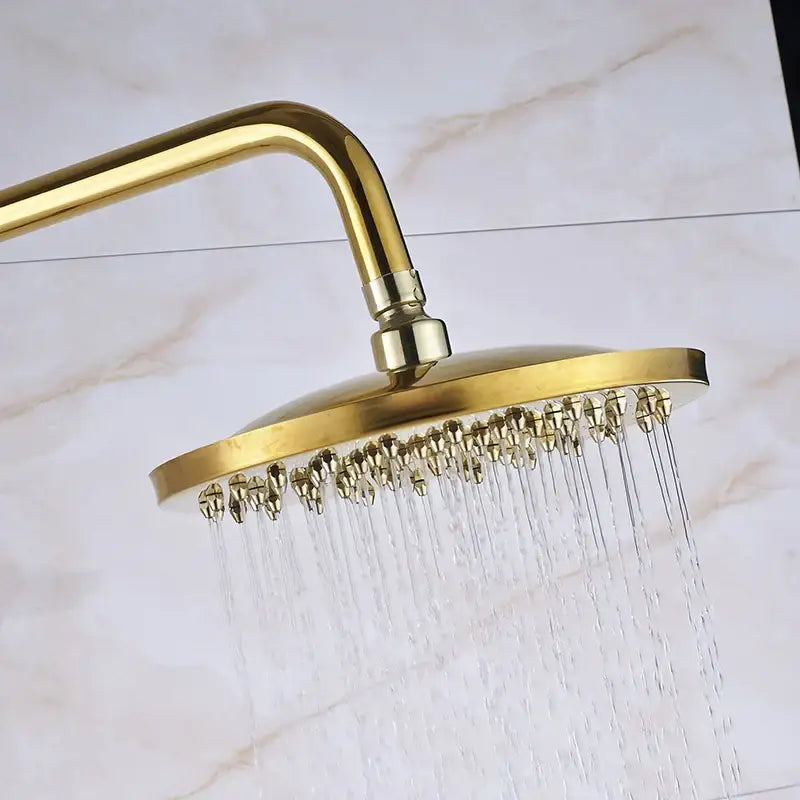 Gold brass rainfall shower faucet set with a round gold-colored showerhead featuring multiple water jets and metallic finish