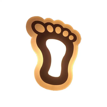 A warm gold and brown crescent led wall light with a glowing foot shape for children’s bedroom wall lights
