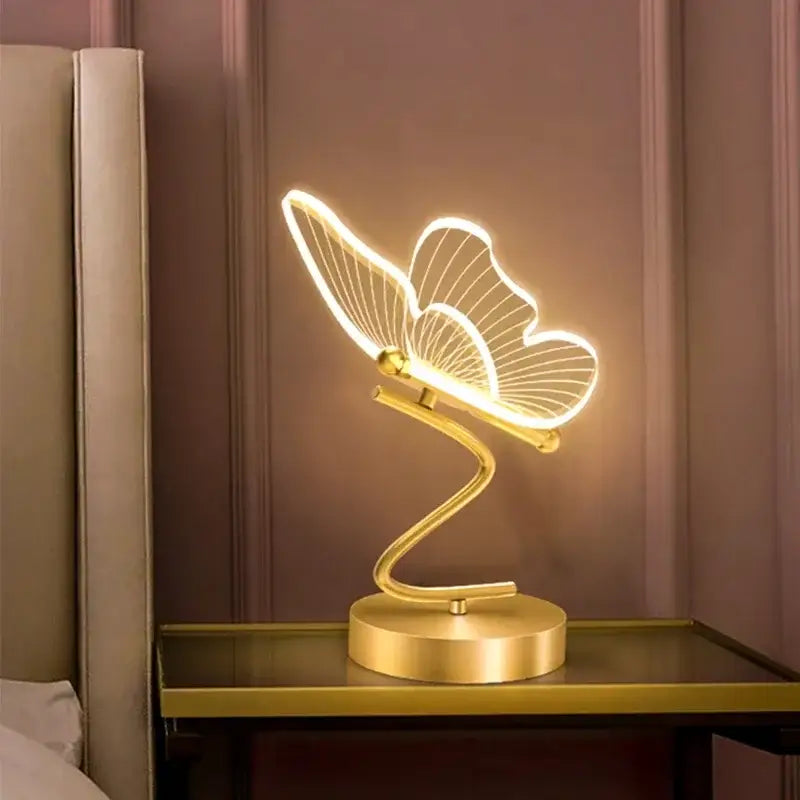 Gold butterfly led table lamp with illuminated wings and sleek curved base ideal for bedroom decorbites butterfly led use