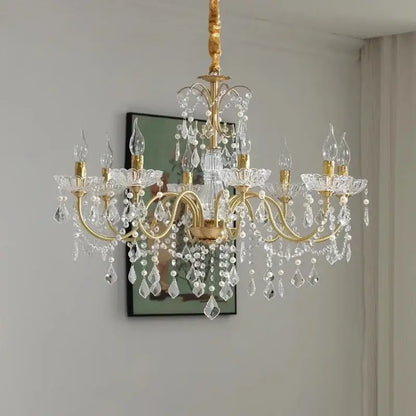 Gold candle style crystal chandeliers light featuring gold-toned ornate arms and clear crystal droplets for dining room decorbites crystal chandeliers