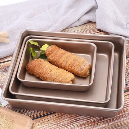 Set of three nested taupe decorbites carbon steel cake baking trays with non stick coating and raised edges for secure baking
