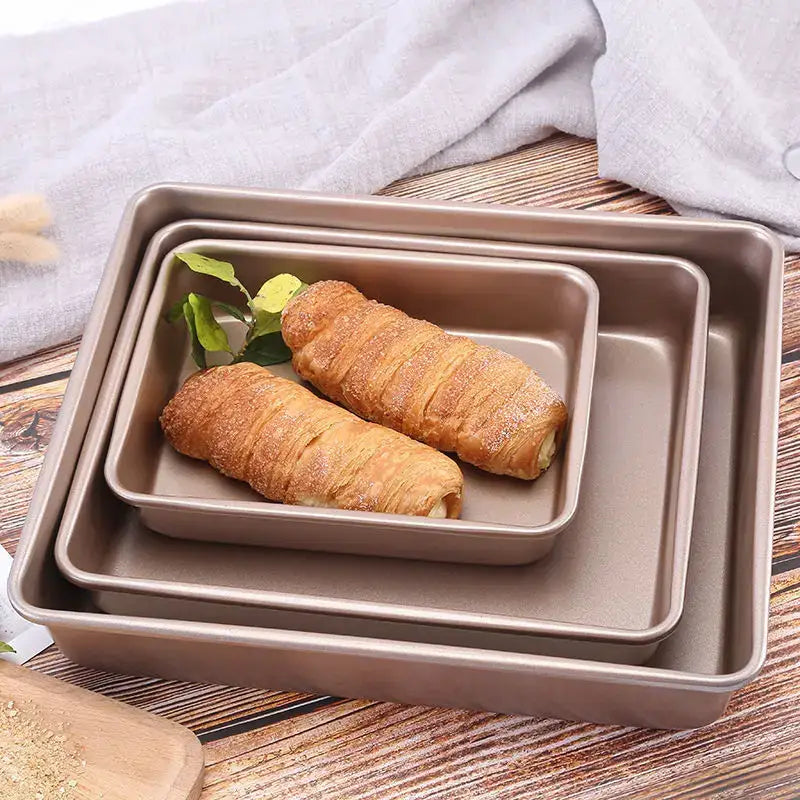 Set of three nested taupe decorbites carbon steel cake baking trays with non stick coating and raised edges for secure baking