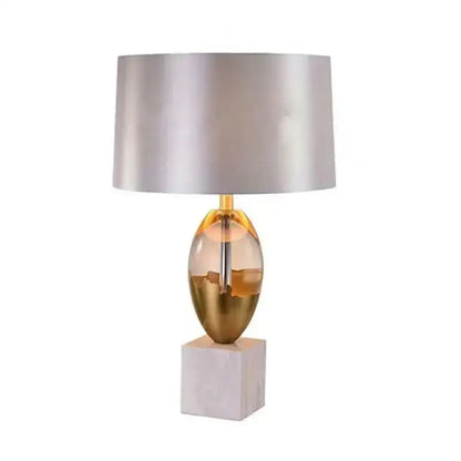 Gold ceramic crystal fabric table lamp with a translucent amber glass base and white marble pedestal for bedroom use