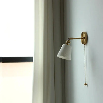 Gold ceramic led wall sconce with ribbed white ceramic shade and pull chain by decorbites for bedroom decor