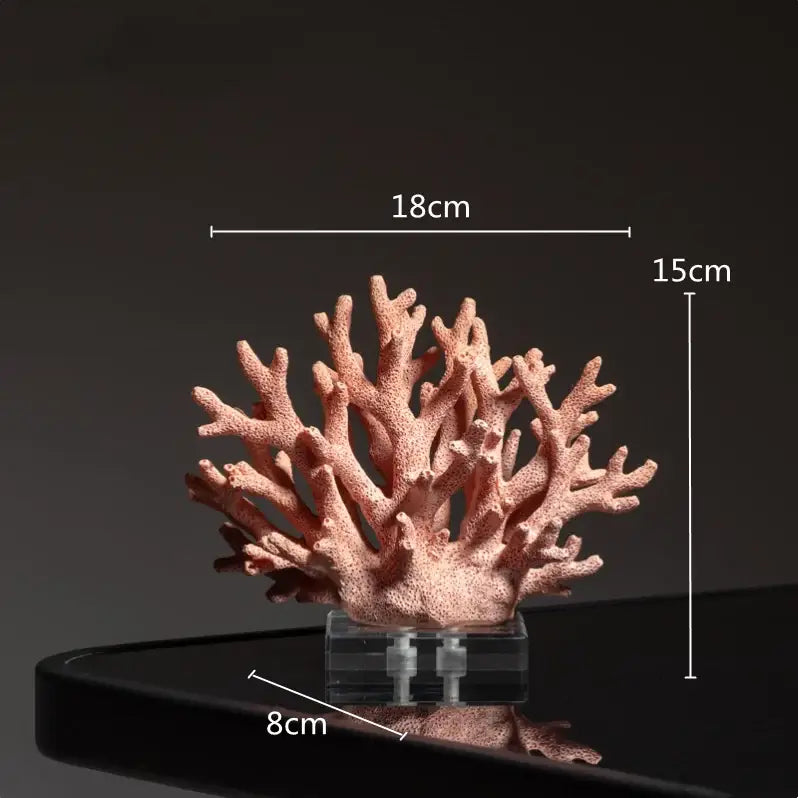 A soft pink coral crystal tree resin ocean figurine on a clear acrylic base for living room decor