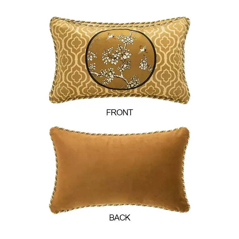 Gold-toned velvet lumbar pillow case with embroidered crane birds branches and white blossoms on tan background