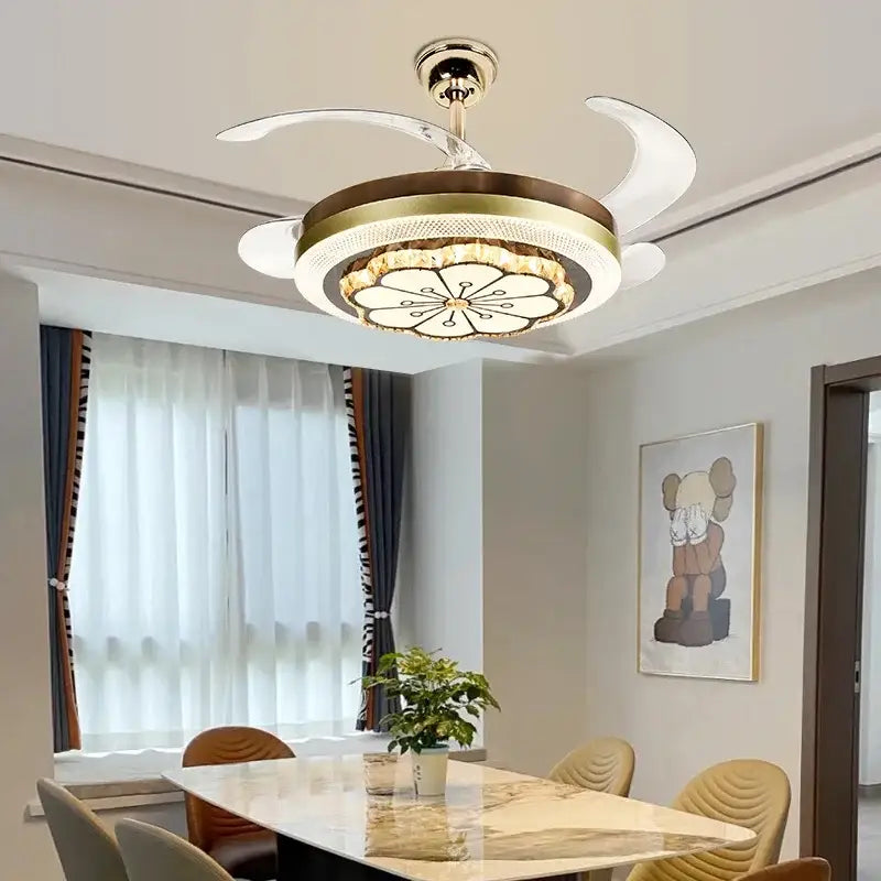 Gold-toned decorbites crystal invisible ceiling fan with integrated lighting and white crescent-shaped blades for living room decor