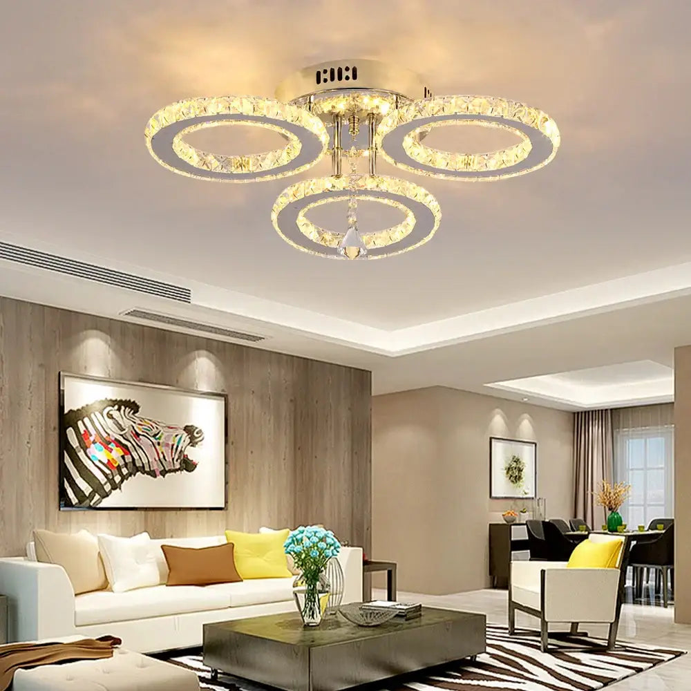 Gold crystal led rings ceiling chandelier with three interlocking crystal led rings and metallic finish for dining room decorbites crystal led