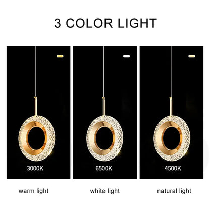 Gold-toned crystal ring led pendant light with textured design and three color lighting options for luxury dining room use