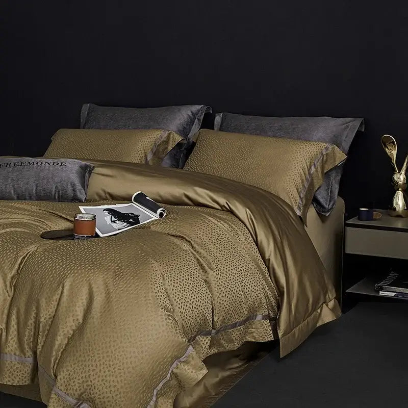 Gold satin duvet cover with subtle leopard print and dark gray pillows in decorbites 100s egyptian cotton bedding set