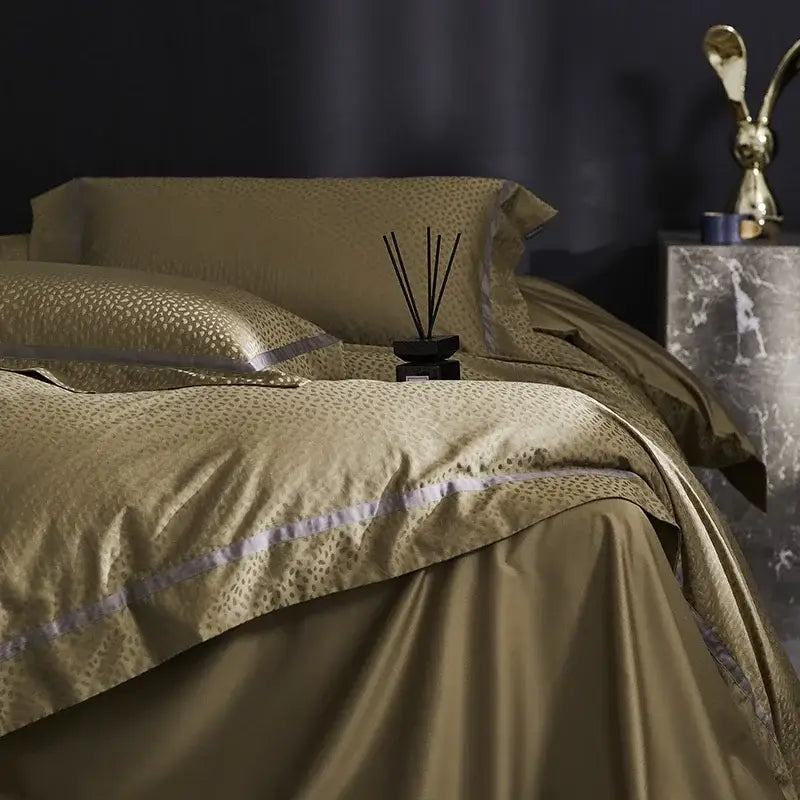 Gold-toned satin bedding set with subtle leopard print and lavender piping from decorbites 100s egyptian cotton collection