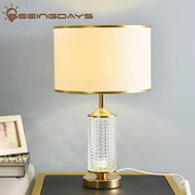 Gold-toned decorbites clear crystal table lamp with faceted clear crystal glass base and off-white fabric shade for bedroom decor