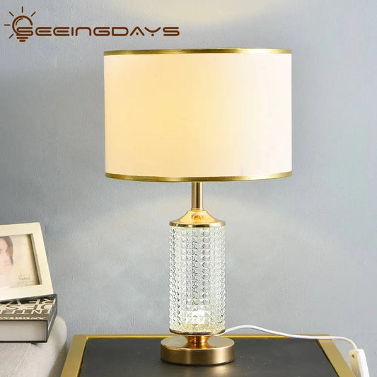 Gold-toned decorbites clear crystal table lamp with faceted clear crystal glass base and off-white fabric shade for bedroom decor