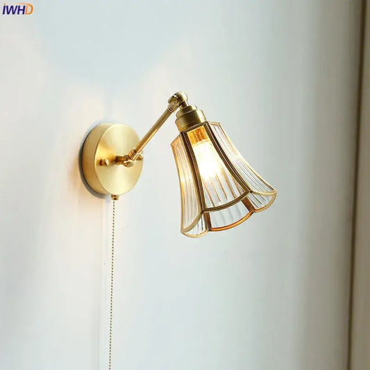 Gold-toned wall sconce with fluted glass shade and articulated arm ideal as a bedroom wall lamp decorbites copper wall