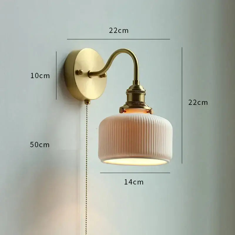 A vintage gold fluted wall sconce with brass metal arm and cream ribbed ceramic shade for elegant bedroom decorbites copper wall lamp