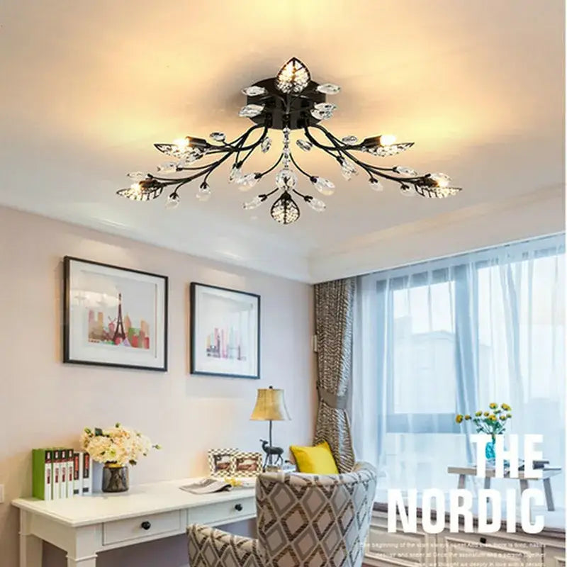 Black wrought iron decorbites crystal ceiling chandelier with crystal accents shaped like a branching tree for living room