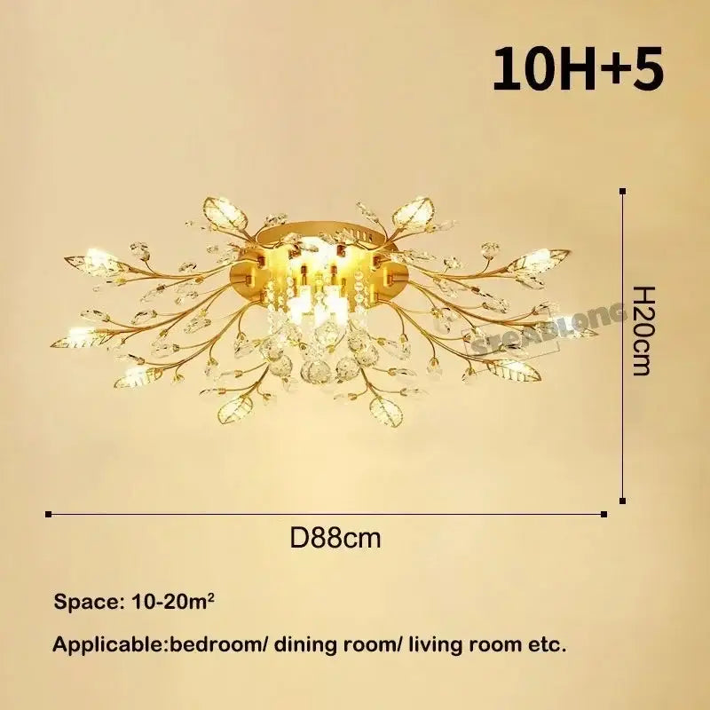 Gold-toned decorbites crystal ceiling chandelier with crystal leaves and dangling crystals in branch-like design