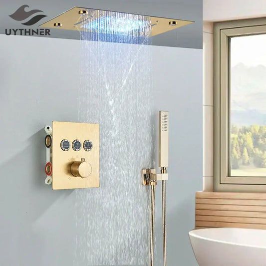 Gold-finished rectangular rainfall waterfall head with integrated led lighting and matching bathtub mixer tap control panel