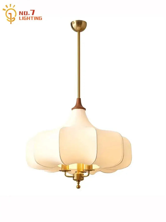 A gold lustre medieval brass pendant light with tiered petal white glass shade and wooden accents for dining room decorbites